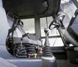 Despite a drab exterior color scheme, the HMEE's interior is quite plush. Joystick controls and cloth air-ride seats with adjustable armrests ease the fatigue of long hours spent loading and digging.