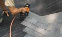 Step 1: Lay shingles through the valley from the first roof plane onto the second with waterproof shingle underlayment lining the valley beyond the shingles being installed.