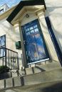 Contemporary Series Storm Door in Forest Green with Nickle Hardware and Etched Glass. Angle shot.