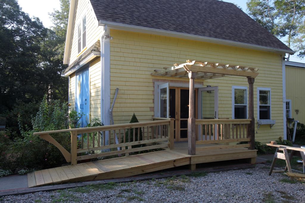 In 2010 I put in new, more weather-tight outswing French doors, as well as a fancier entry with equipment ramp and pergola.