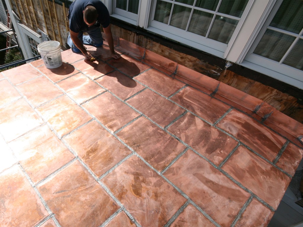 A year ago, I was asked to install a flat-seam copper roof on a new entry portico. The homeowners chose copper for its longevity and because the roof was visible from windows located in a second-story sitting room. My company, New Dimension Construction, was subcontracted only to do the copper work.
