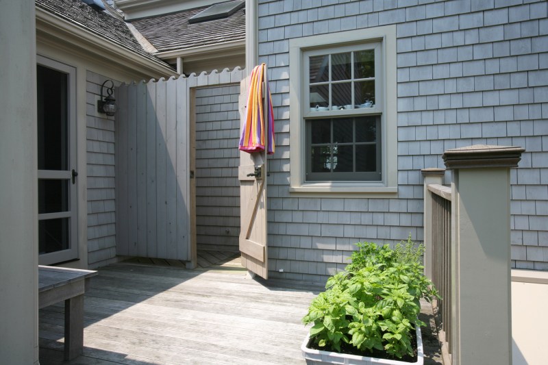 Many Cape Codders use their outdoor showers for more than just places to wash the beach sand from their feet. These little outdoor gems become their principle showering spots during all but the coldest months of the year. In the spirit of the nearby ocean, this outdoor shower sports wave shapes carved into the enclosure boards.