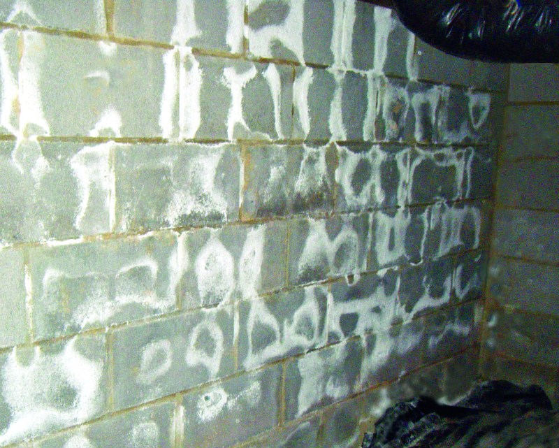 Unsightly salt. White deposits on concrete block are salts that leach from the block as moisture passes through. The deposits don’t do any structural damage to the block, but should be dry-brushed off and thrown away.