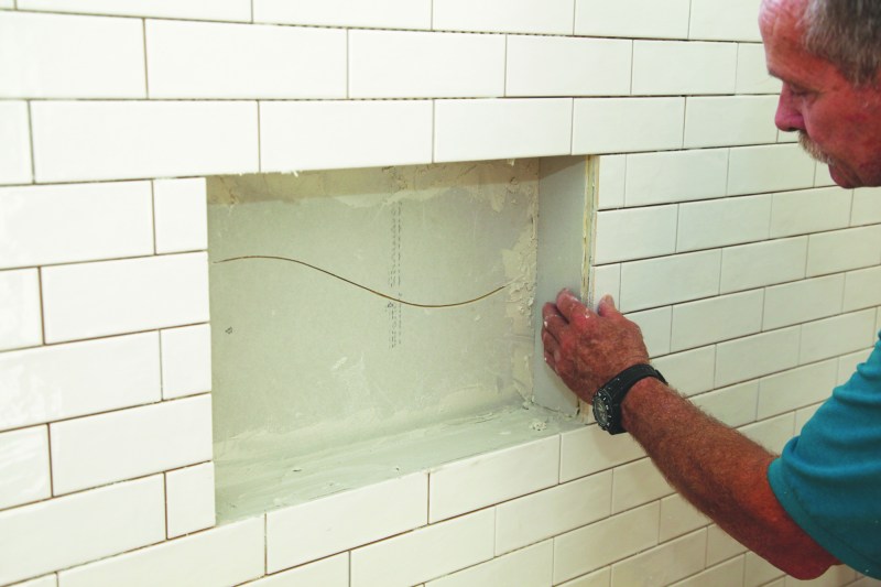 To waterproof a tiled niche, apply waterproof backerboard to the inside surfaces of the niche. (The back wall of this nichewas in two pieces to facilitate installation.)