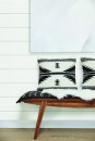 Wood bench with pillows in farmhouse hallway of small cottage home