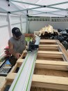 Emanuel Silva uses the new jamb to guide the placement of the track saw as he trims the frame to size.
