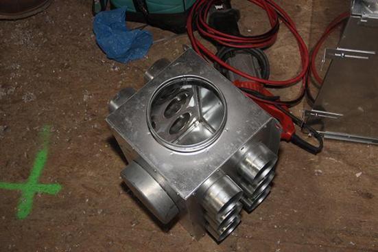 This metal manifold, supplied by Air Pohoda, will serve as the return manifold for the Placetailor-design ERV system at the Roxbury “Supply House” project. The manifold lacks any sound attenuation characteristics, but the designers considered it adequate for the return lines of the system. However, the designers chose a Zehnder manifold with sound-attenuating mass-loaded vinyl core elements for the supply side of the air distribution system.