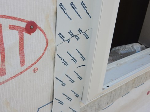 Poorly adhered flashing is common. The SAF is often applied with hand-pressure only, not properly J-rolled. This means the flashing does not have an even, flat surface to stick to. Air gaps and wrinkles develop under the flashing. And, if the weather is cold or wet, adhesion problems develop as well. These can lead to even worse problems if the flashing has not been shingled properly. Install continuous-length flashing, if possible. If not, do not reverse lap the SAF as seen in this photo.  With a drainable housewrap, water can migrate laterally much easier than if the housewrap is not drainable.