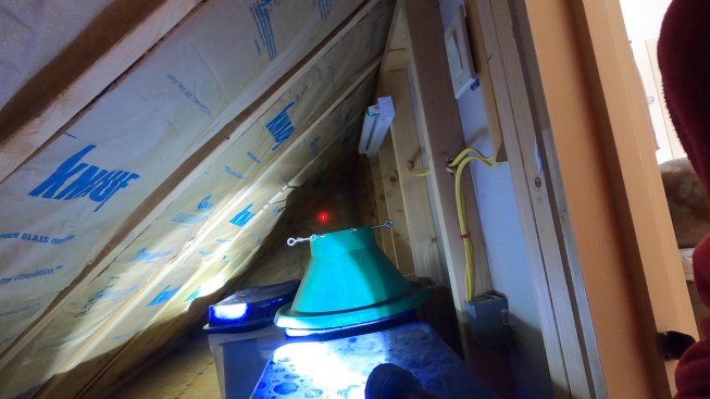 In the main house, the space behind the knee wall is used for storage. Here, kraft-faced fiberglass batts had been installed in the rafter bays. Propavent baffles between the batts and underside of roof sheathing were butted end to end and were not air-sealed (not shown). This, along with the baffles being loosely affixed to the underside of sheathing, allowed some wind washing of the insulation, reducing its performance.