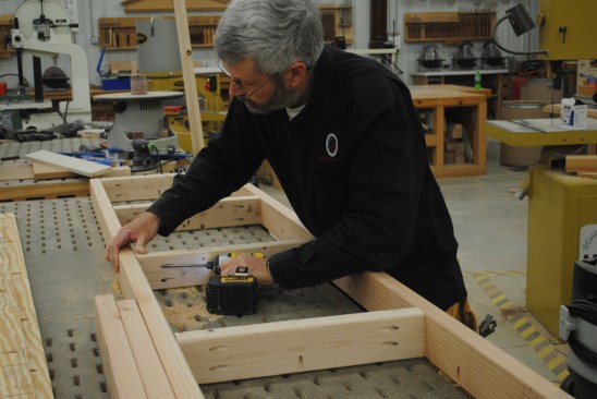 The table-saw stand and worktable starts with a 2-by frame pocket-screwed together.