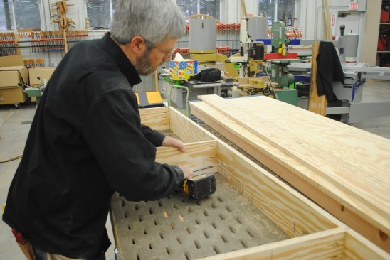 A lightweight storage shelf adds to the usefulness of the worktable. Pocket-screw the plywood frame together.