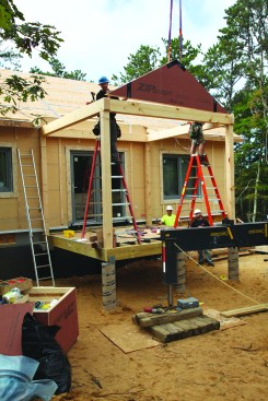 The main porch uses a timber frame to support the roof, but prebuilt gable panels sit onthe frame.