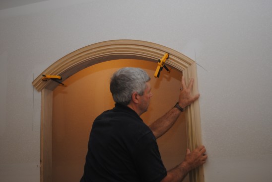 Working one side at a time, cut the miter on the arch and the side jamb mite. Tweak the cuts until the fit is perfect. Then repeat the process on the other side.