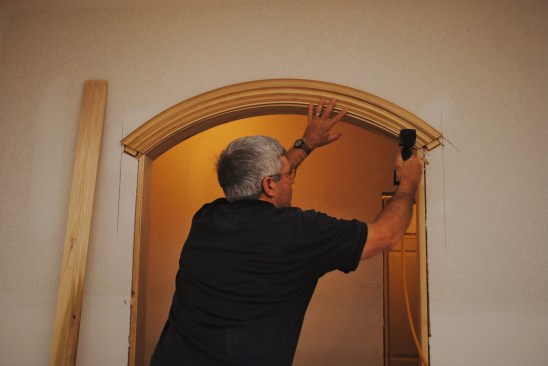 The arch is nailed in place with small pockets cut in the drywall for the gussets.
