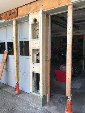 Solid 2-by blocks span between the studs on either side of the garage support to addrigidity.