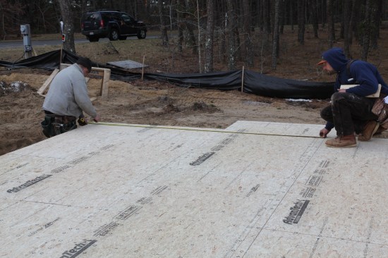 The crew measures from the secondary baseline for the other end of a front wall.