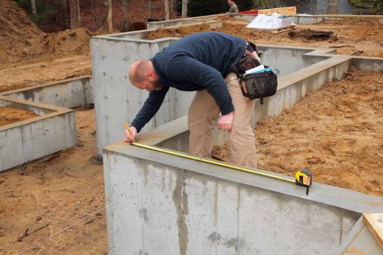 Once we had this line established, it was easy to pull parallel measurements for each of the four walls along the front elevation. We then snapped chalk lines between each set of measurement marks.