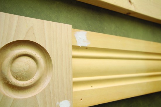 He leaves plenty of filler on the surface so that the filled hole can be sanded rather than filled a second time.
