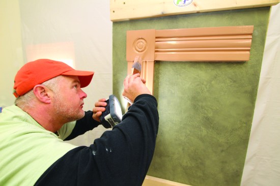 While the paint is still wet, he sights every surface with a hand-heldLED light, and corrects any problems before the paint begins to dry.