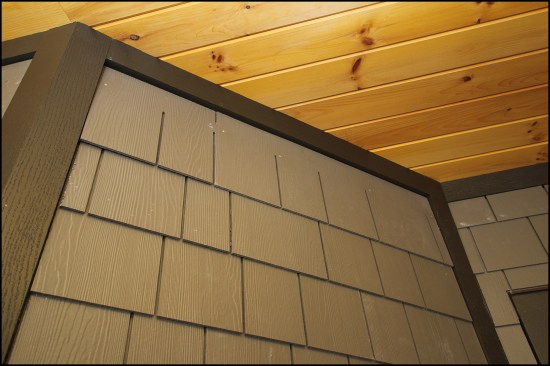 Shingles run up to the underside of the trim. Later, individual shingle tabs will be cut from scrap, then predrilled and face-nailed.