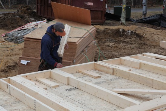 Next the cripples and sills are distributed to the  window openings. At each opening one of the sills is positioned against the plate, and the layout for the cripples is transferred onto the sill.