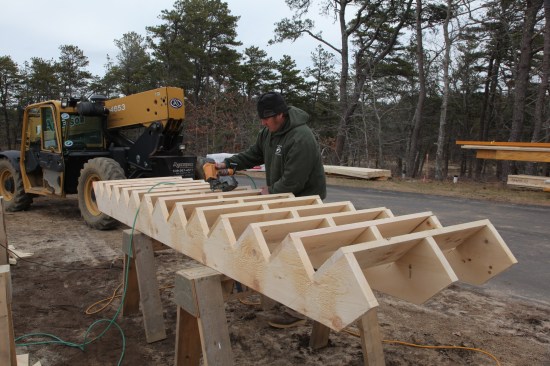 With rise and run taken from the plans, stairs are built ahead of time and installed when the deck framing is done. Solid stairs make it safer and more efficient for workers to move between floors during construction.
