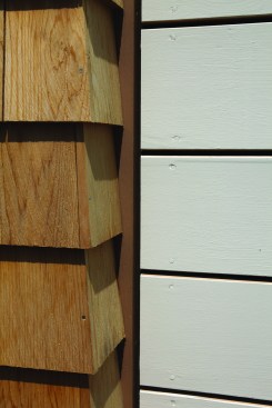 The siding—1x6 boards painted on all four sides—is installed with a 3/16-inch gap between the boards and all adjacent material. The gaps provide ventilation for the back of the siding.