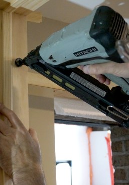 Drive a single nail above the shim. The pressure from the nail keeps the shims from moving, but allows them to be adjusted easily if necessary.