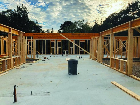 When the slab was finished, the framing crew built and raised the exterior walls to support the truss roof.