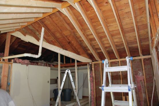 With the roof supported, all the original ceiling joists were taken out and the old roof at the valley supported temporarily with vertical 2x4s until a new double 2x10 valley was in place between the ridge and the inside corner of the ell.