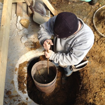 When the level was nearing the top of the form, the author pushed pieces of rebar into the wet concrete for reinforcement.