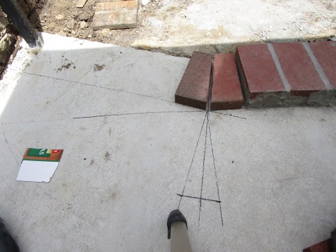 The template transfers the angle cuts to the bricks at the pivot point of the flare, and the rest of the bricks can then be laid out along the edge of the flare.