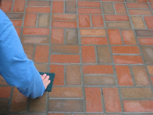 After the mortar has cured overnight, a course scrub pad cleans off any residual mortar. 