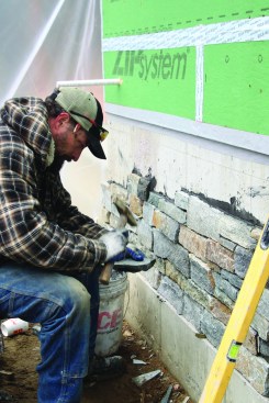 To make the cut edges less visible, the crew installs them facing downward. To fine-tune the fit of a stone, a mason uses the chisel end of a masonry hammer to chip away unwanted material.
