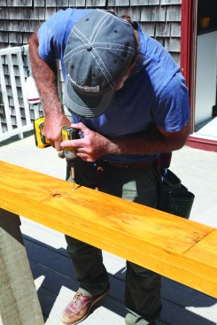 Then he drives the appropriate fasteners at each location.