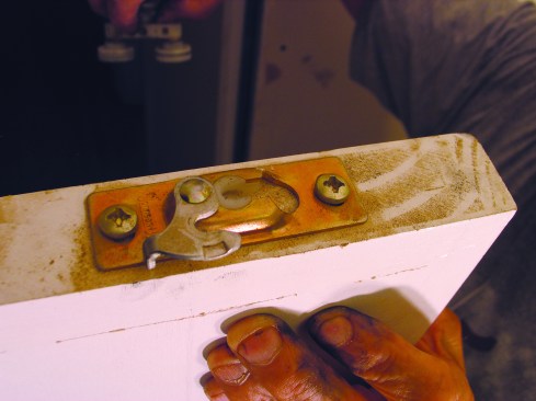 I mounted the two supplied door plates on the top of the door, 2 inches from each end. 