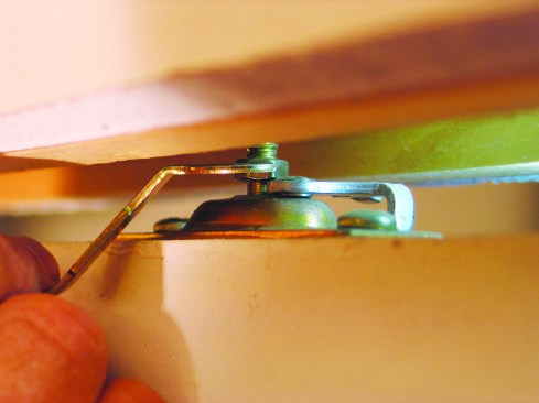 Using a special wrench supplied with the hardware kit, I raised or lowered the hangers until the edge of the door fit perfectly against the jamb.