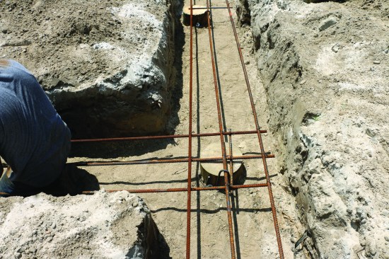 At intersections, the rebar from one trench sits on top of the other and they are tied together.