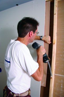 The author attaches a splicer to land a butt seam between studs.