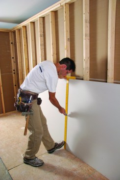 Drywall T-squares help guide crosscuts.