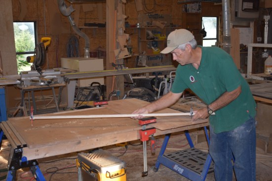 After calculating the radius of the curve, the author finds the pivot point using a trammel beam set at the radius. He swings the radius from both sides of the step blank and the pivot point is where the two lines intersect.