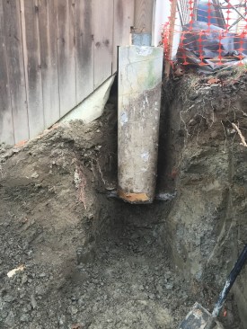 As the job progressed, it became evident that most of the concrete piers supporting the house were deficient. This pier, for example, had no footing and did not extend below the frost line.