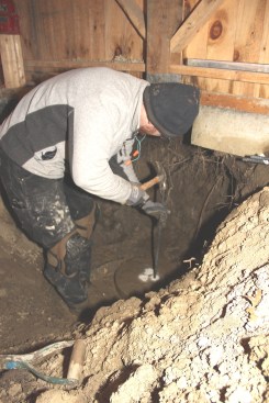 Chris pounds rebar pieces into drilled holes in the precast footing for the new pier.