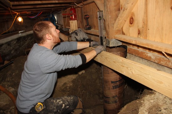 Chris checks the newly placed Sonotube for plumb.