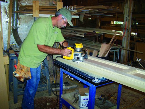 A router with a flush trim bit takes off the excess material. A little sanding, and the joint between the sides and face frame becomes almost invisble.