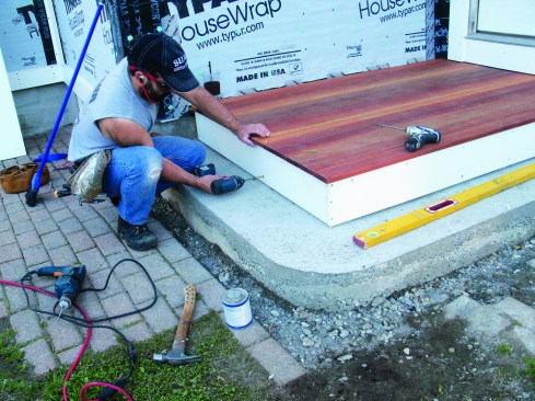 Stainless steel screws through the top holes secured the trim to the sleepers.