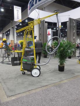 This odd looking contraption is an 
Oztec Concrete Ceiling Grinder. I talked to a guy at the booth and he said it is used to remove the ridge that is left at the joint between forms. This thing is basically a grinder head connected to a big motor by a monstrous flexible shaft. The head is attached to a spring-loaded arm that holds it against the ceiling. This particular setup costs something like $3,800.