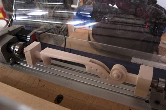 With an indexer —a lathe-type work holder—attached to the desktop unit, this violin neck was cut out in-the-round without the need for a more complicated 5-axis CNC machine.