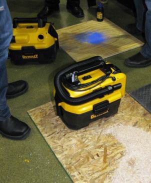 The vacuum in the foreground is the AC/DC model; the one in back is cordless only. Note the cord wrap on the AC/DC model and how neatly the hose stores on the machine. A crevice tool stores in the handle and a wider nozzle on the side of the housing.