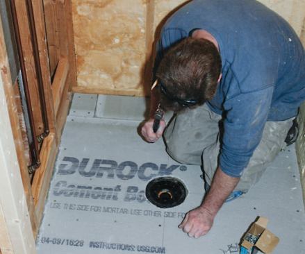 The floor sheathing brought the surface flush with the drain flange.